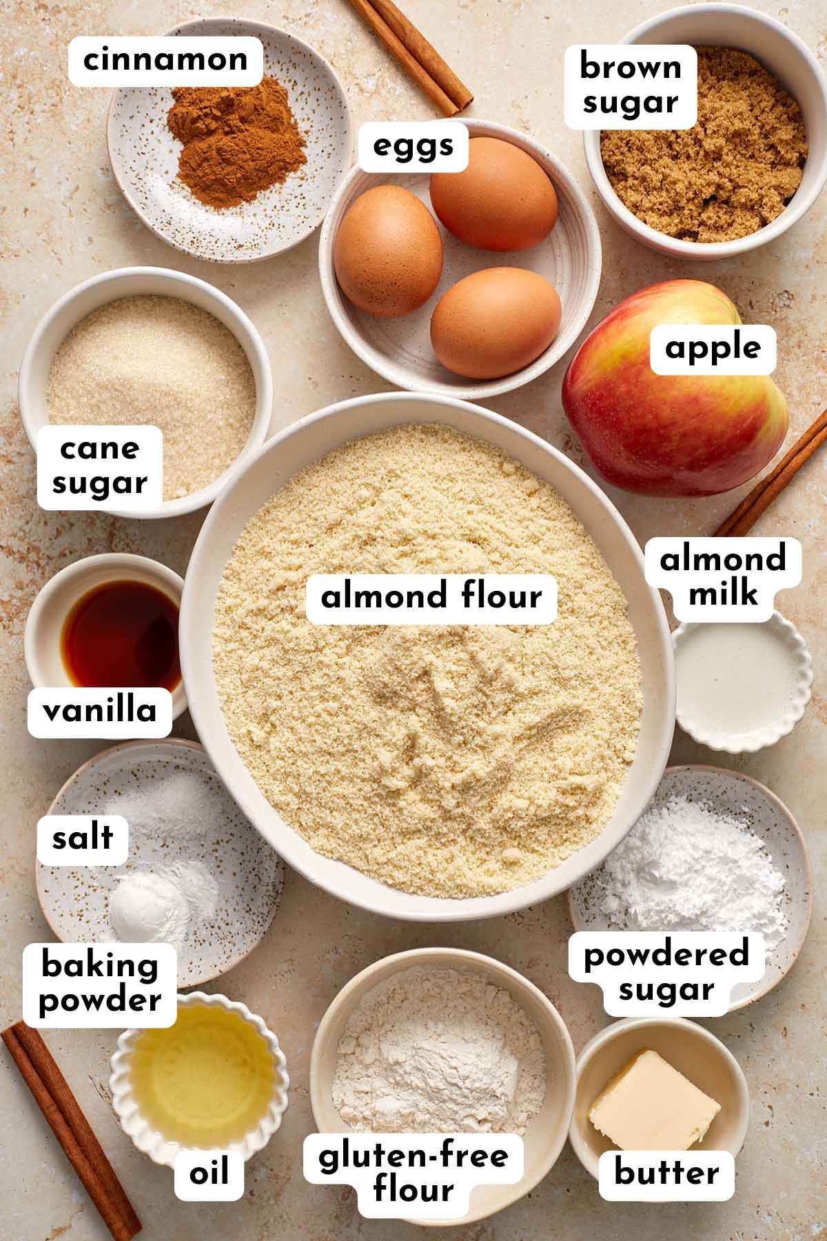 Ingredients for making almond flour apple cake arranged individually and labeled.