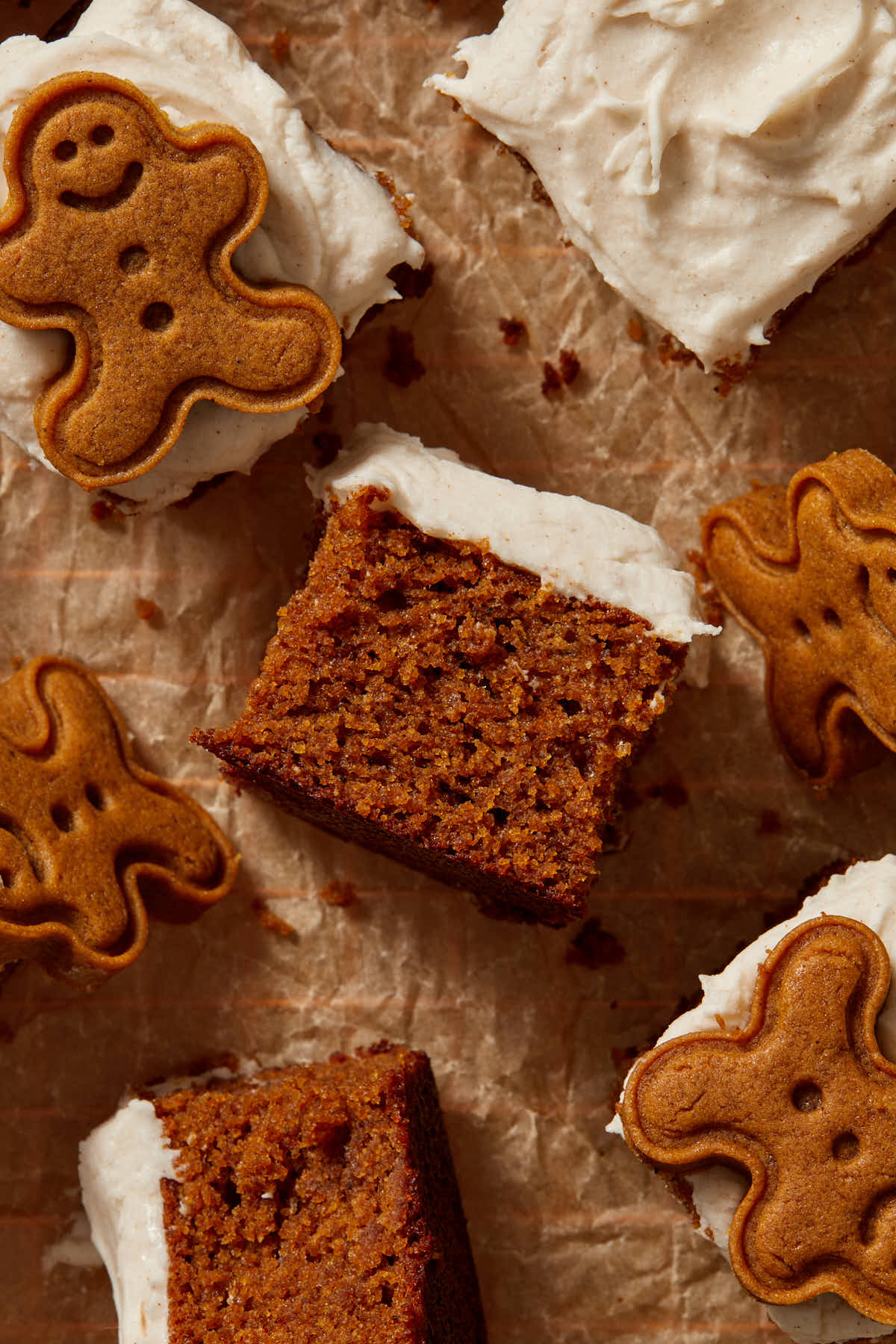 Pieces of cake turned on their sides with gingerbread men cookies scattered around.