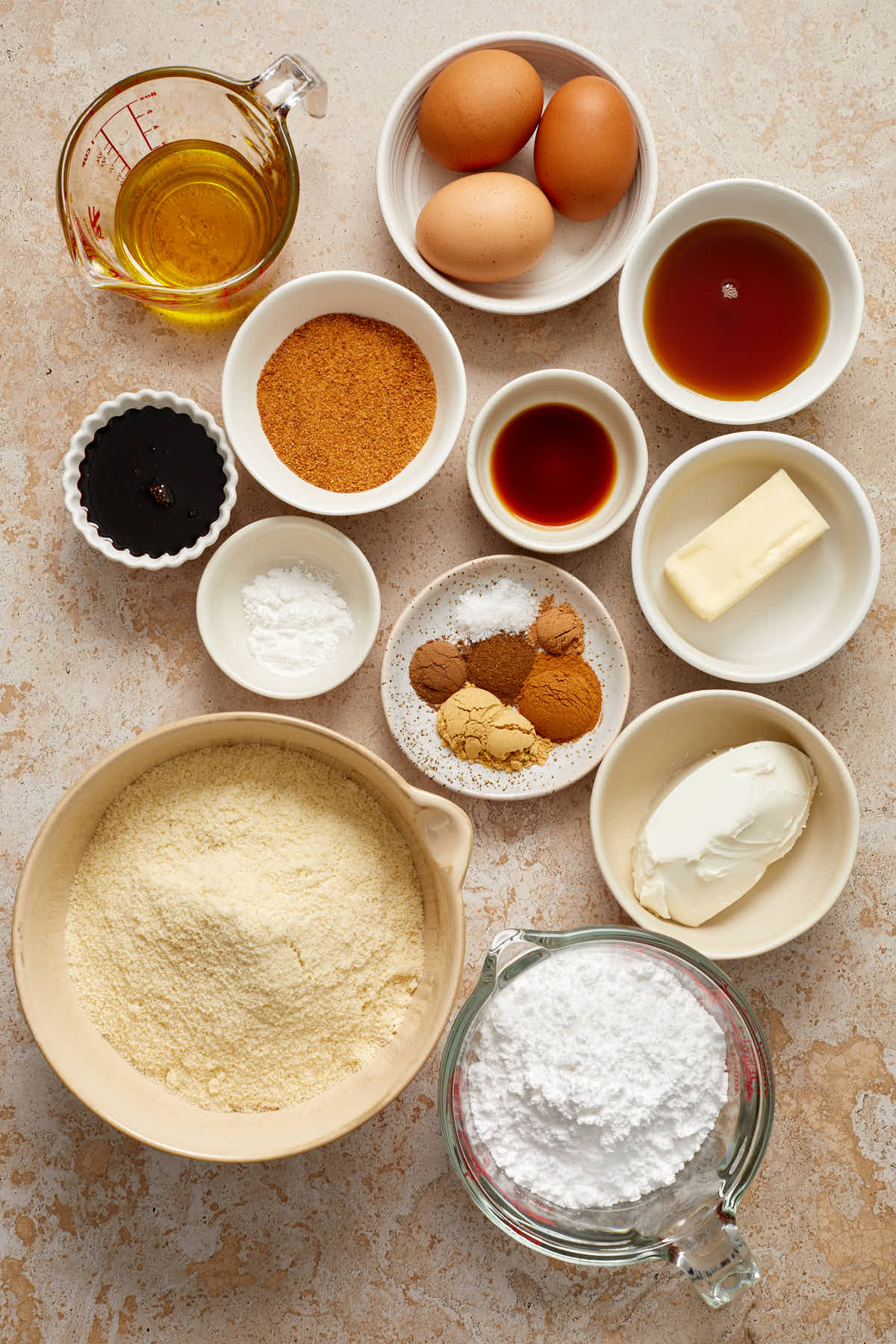 Ingredients to make almond flour gingerbread cake arranged in individual dishes.