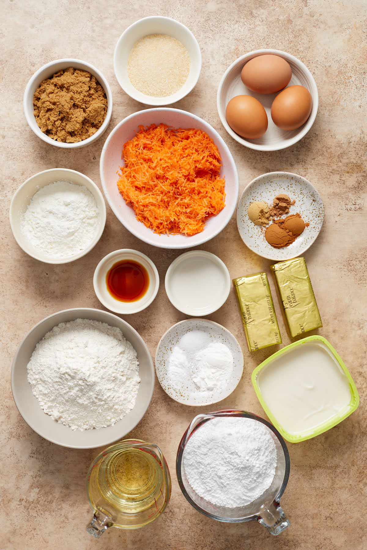 Ingredients for gluten-free carrot cake cupcakes arranged individually.