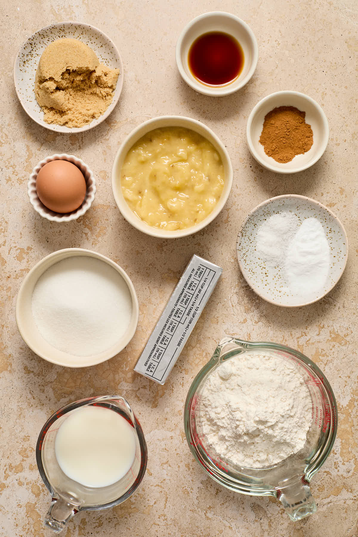 Ingredients to make banana cake arranged in individual bowls.