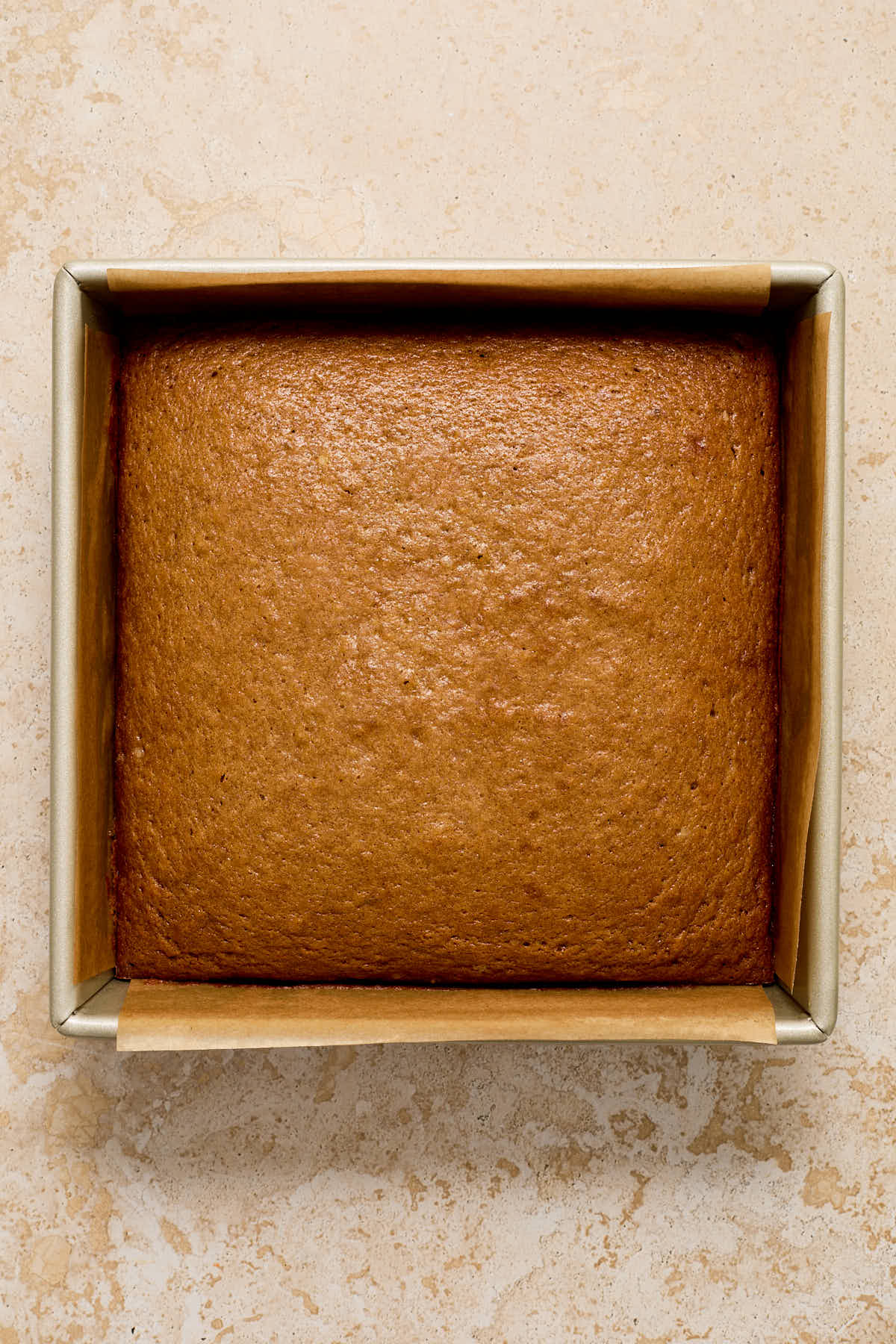 Cake baked up in a square pan.