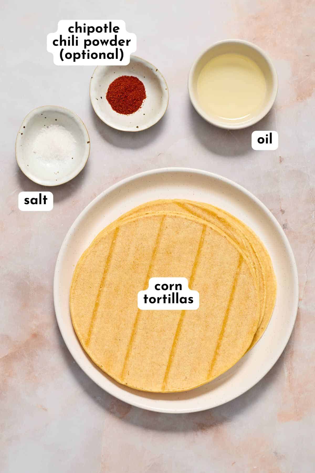 Ingredients to make air fryer tortilla chips arranged individually and labeled.