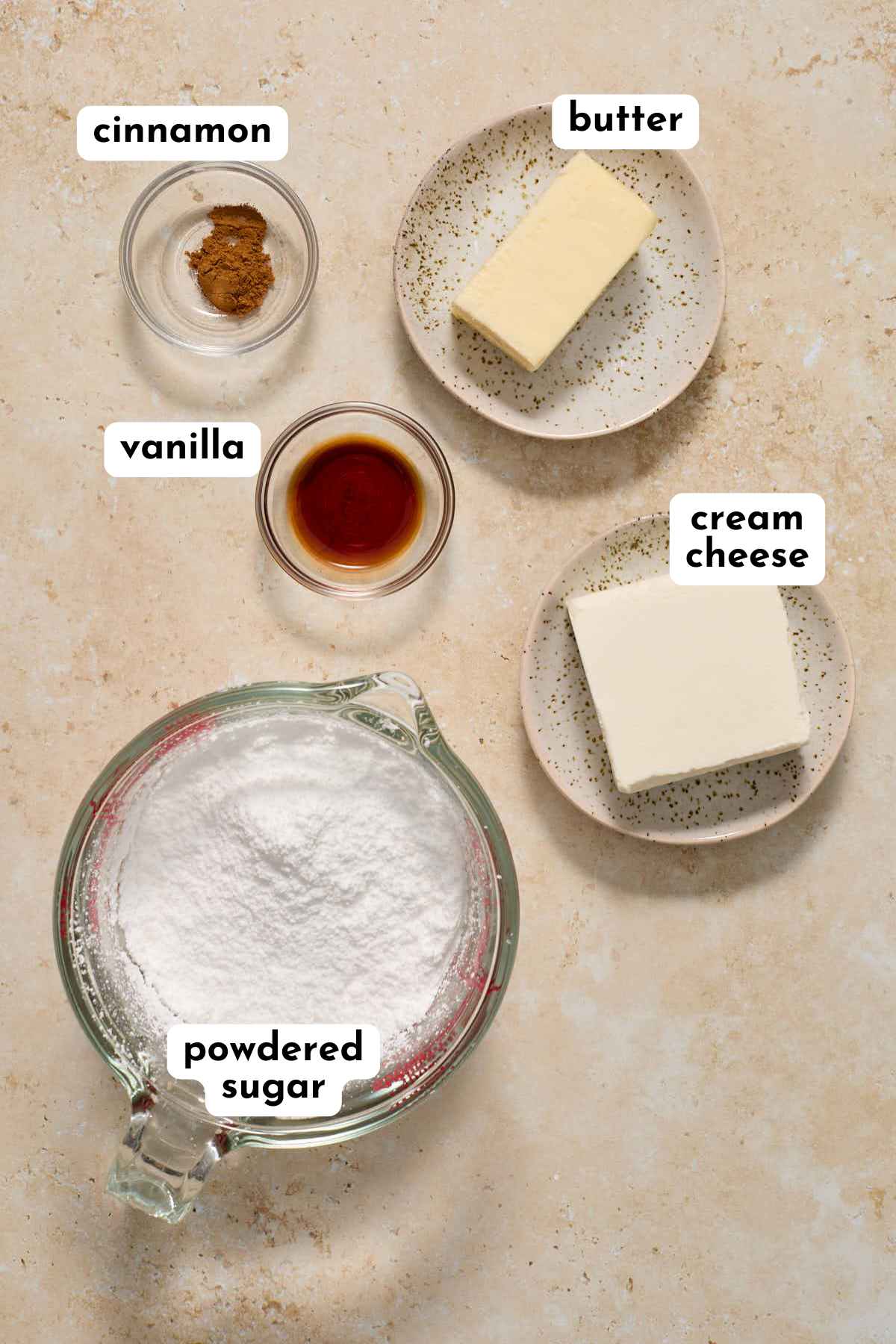 Ingredients for making cinnamon cream cheese frosting arranged separately and labeled.