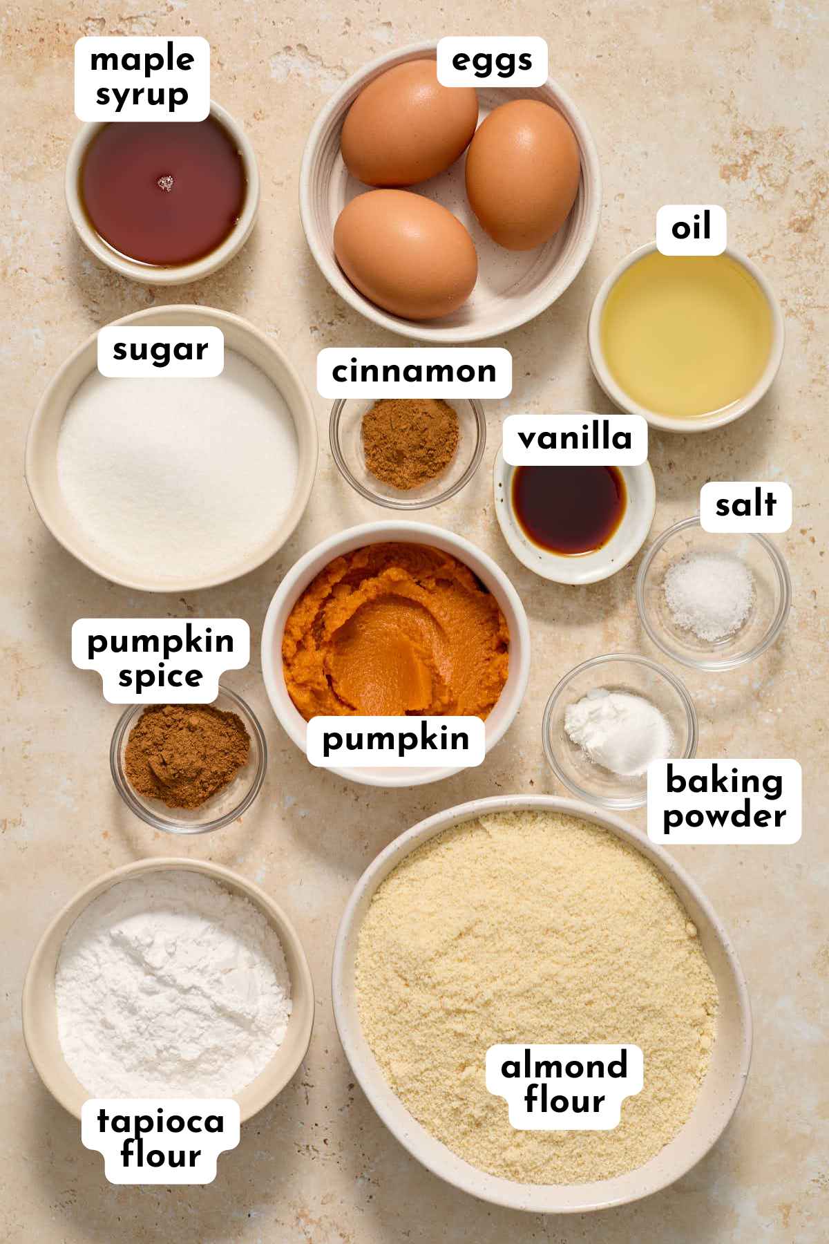 Ingredients for making almond flour pumpkin cake arranged separately and labeled.