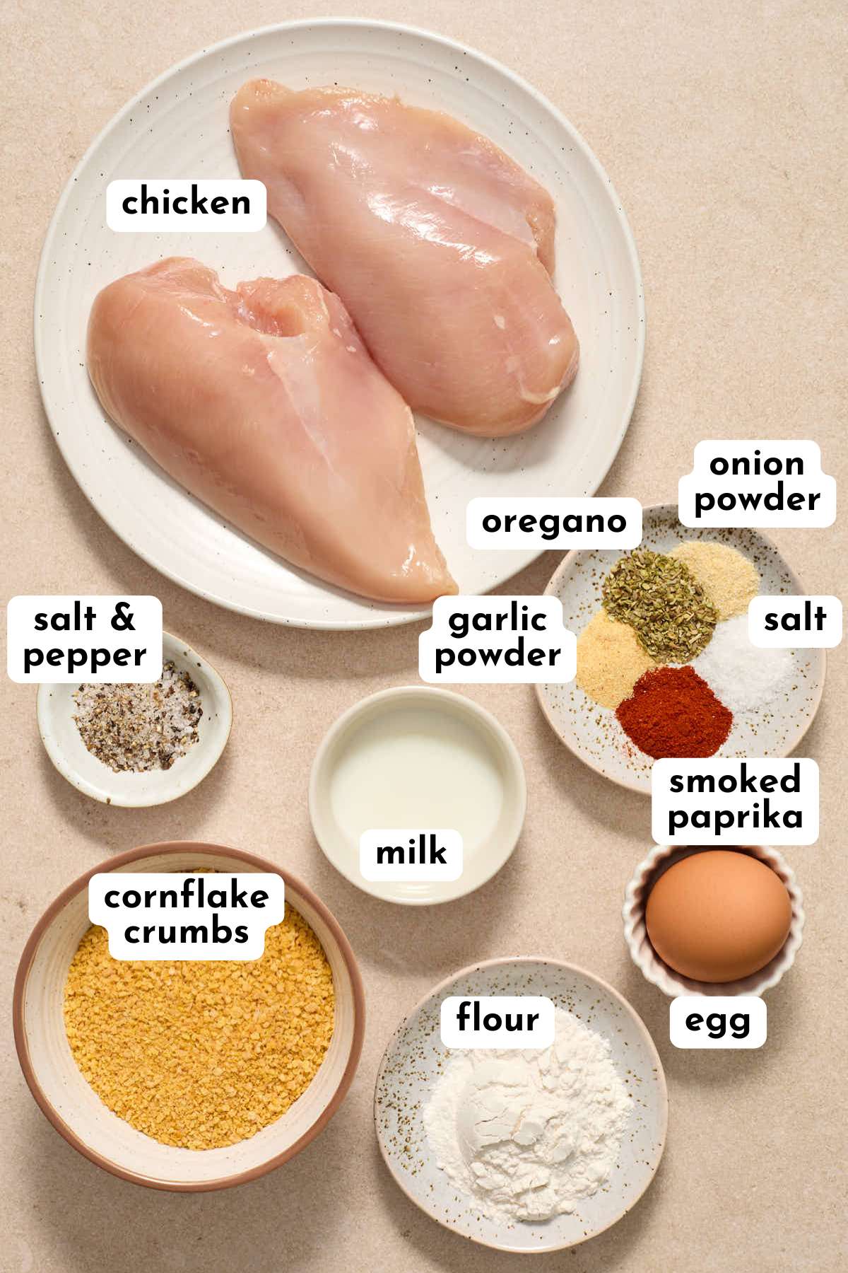 Ingredients to make air fryer cornflake chicken strips arranged individually and labeled.