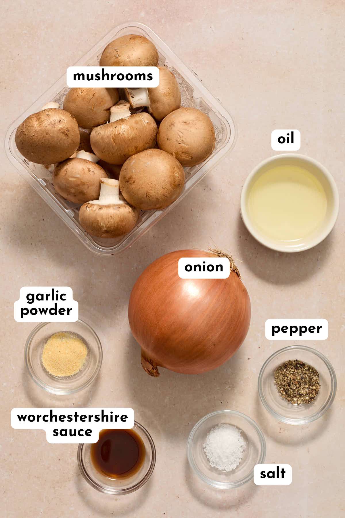 Ingredients to make air fryer mushrooms and onions arranged individually and labeled.