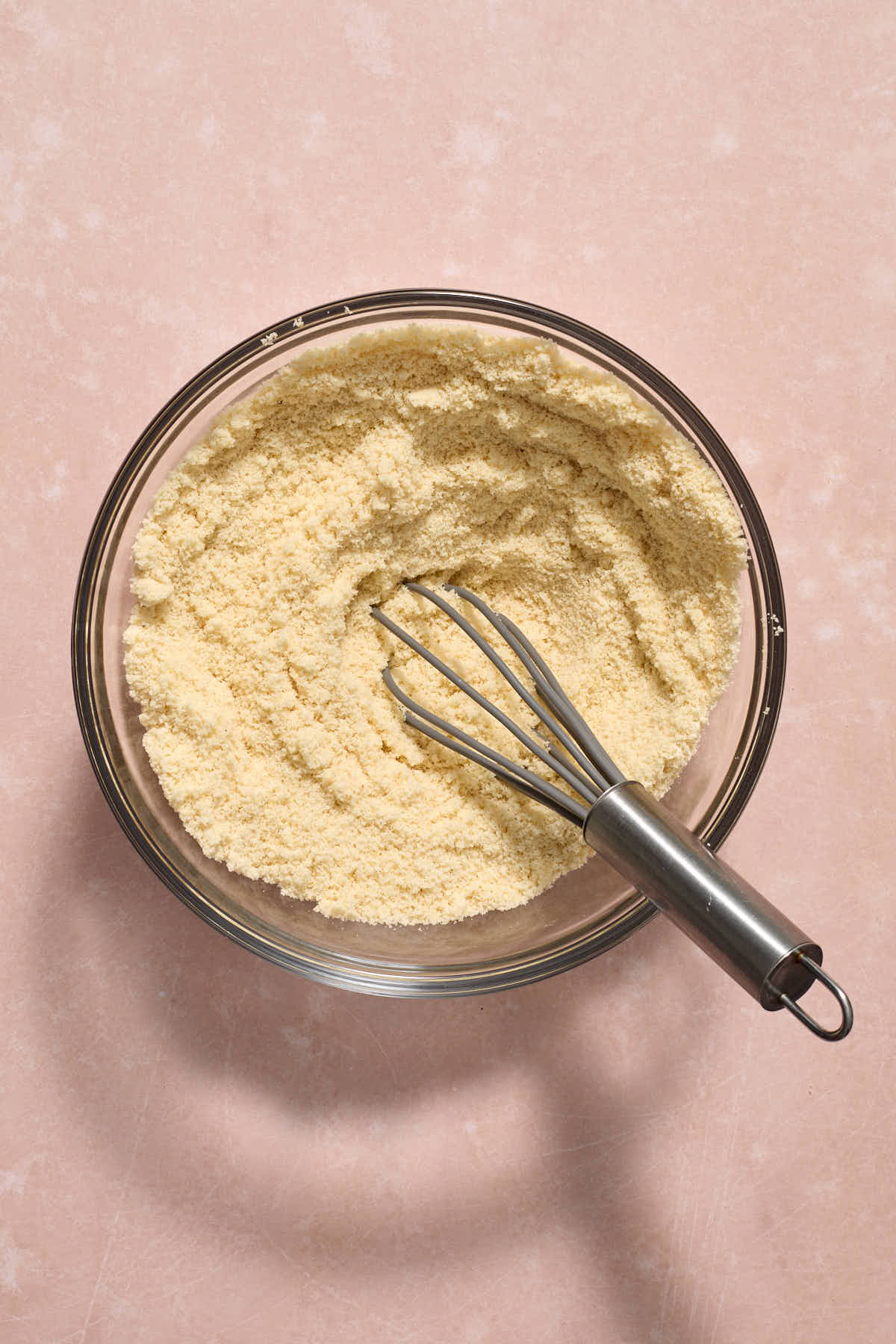 Dry ingredients whisked together in a glass bowl.