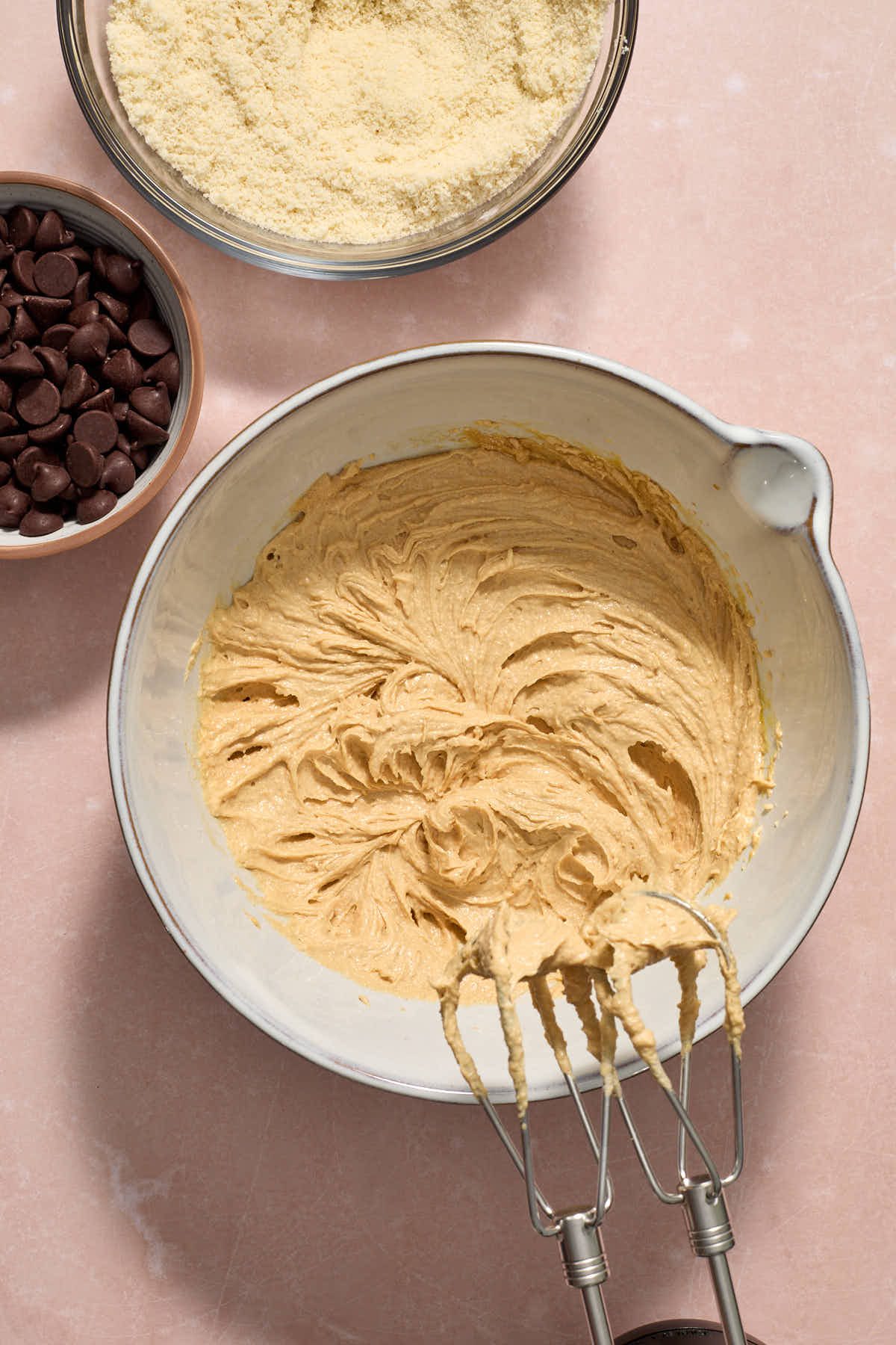 All the wet ingredients mixed together in a bowl with the dry mixture and chocolate chips on the side.
