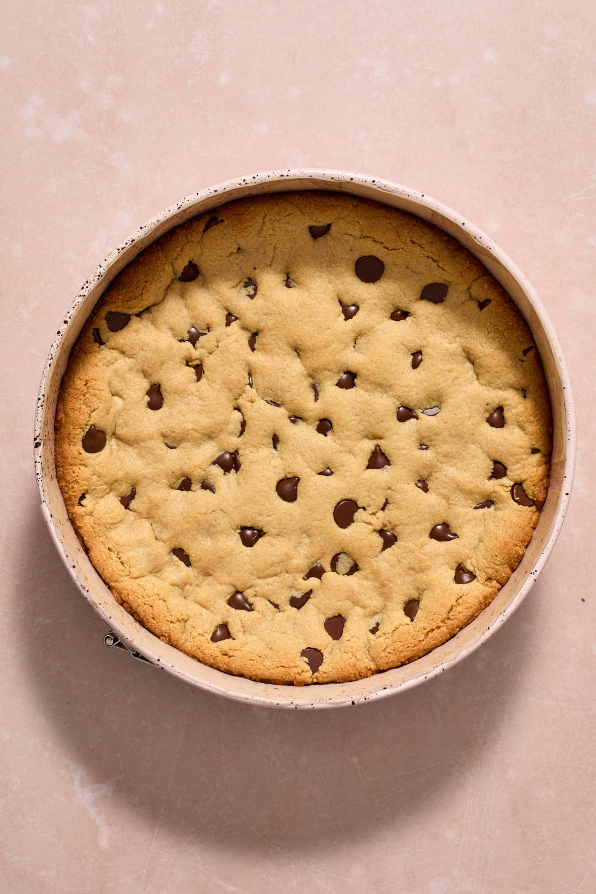 Cookie cake baked and cooling in pan.