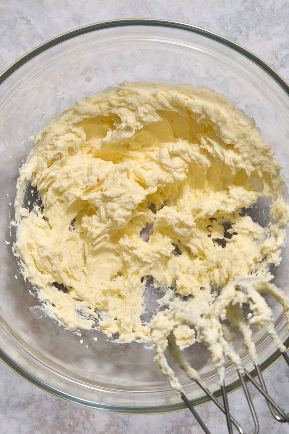 Sour cream and butter creamed together in a glass bowl.