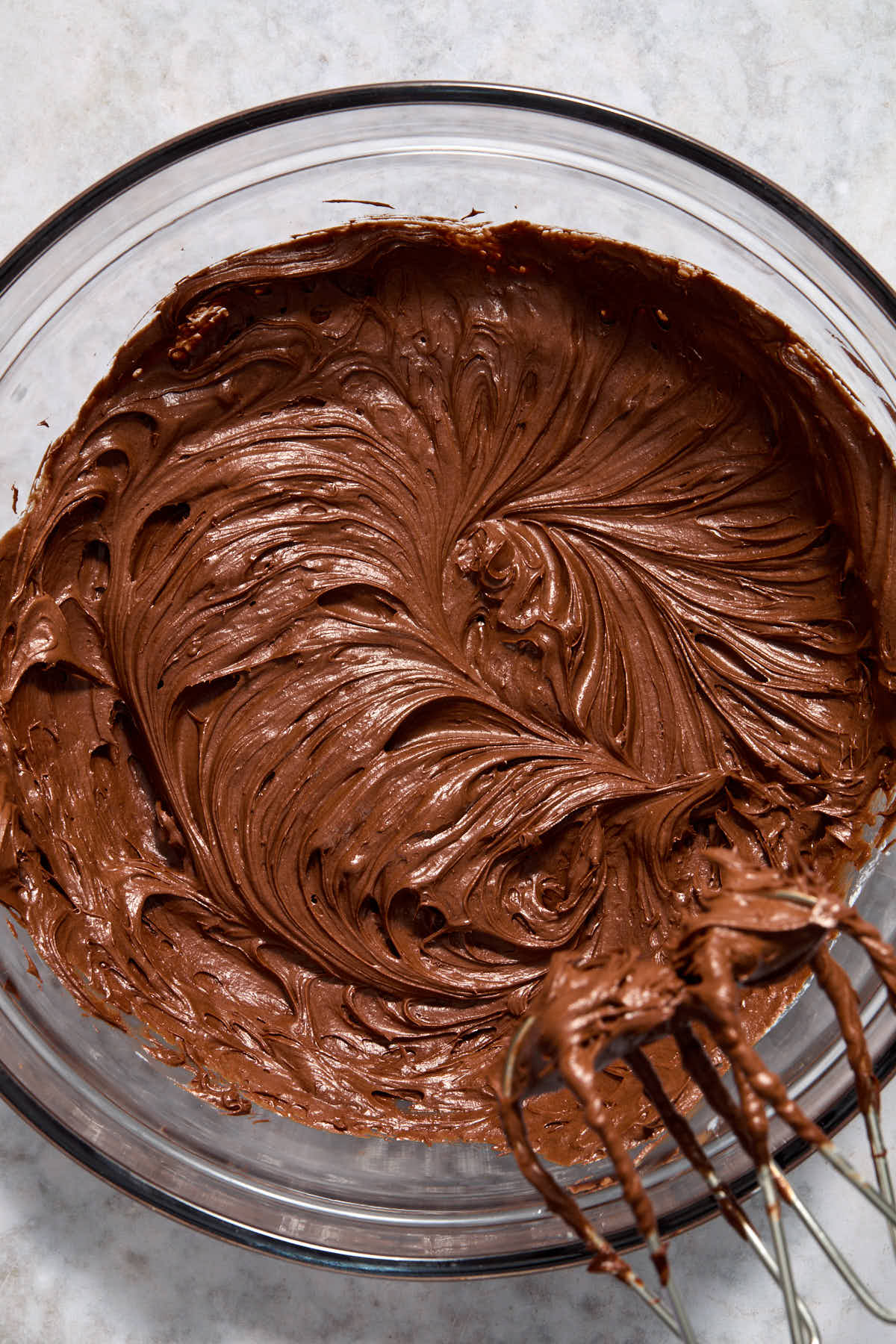 Frosting whipped together in a glass bowl.