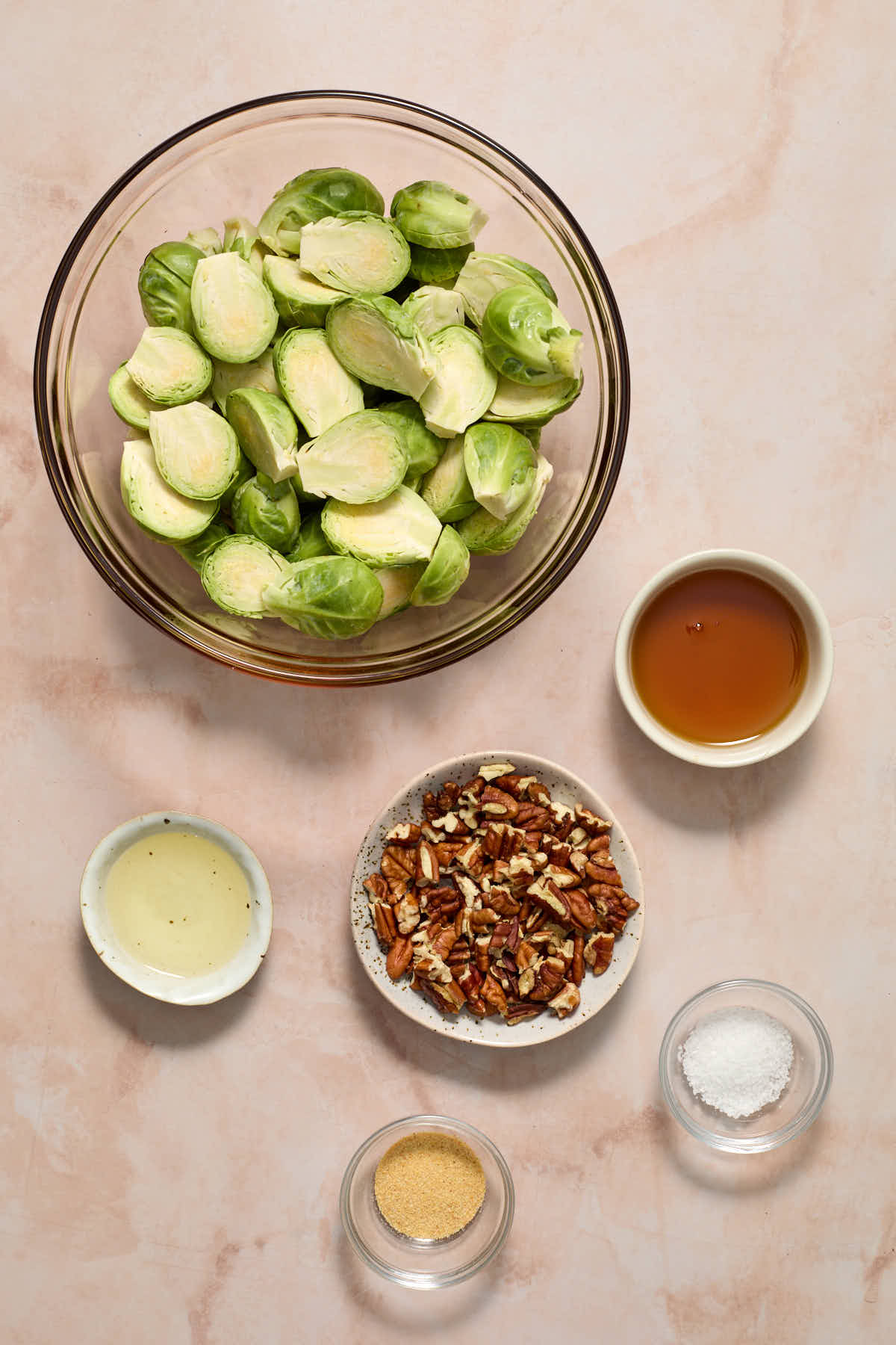 Ingredients to make air fryer Brussels sprouts arranged in individual bowls.