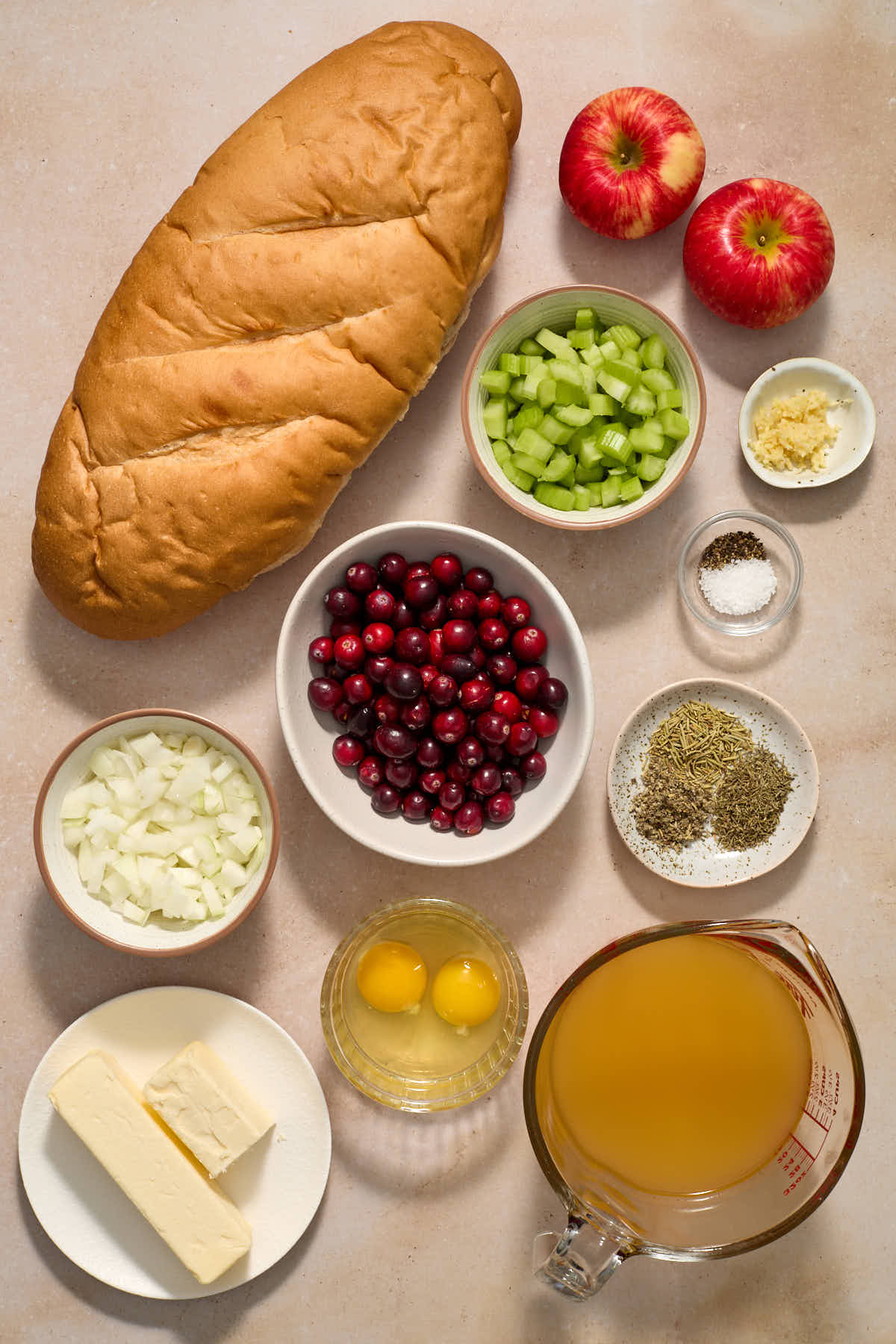 Ingredients to make apple cranberry stuffing arranged individually.