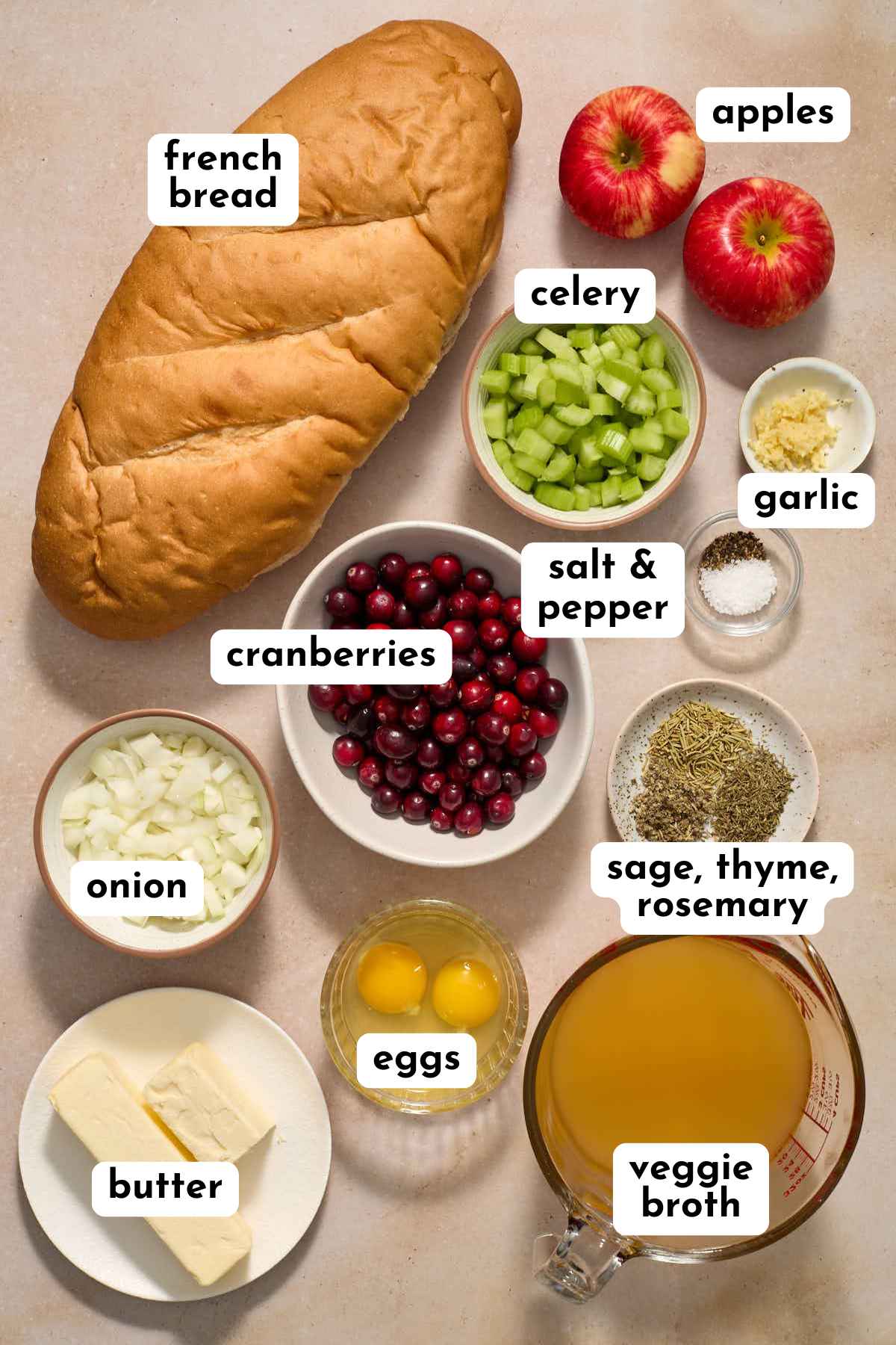 Ingredients to make apple cranberry stuffing arranged individually and labeled.