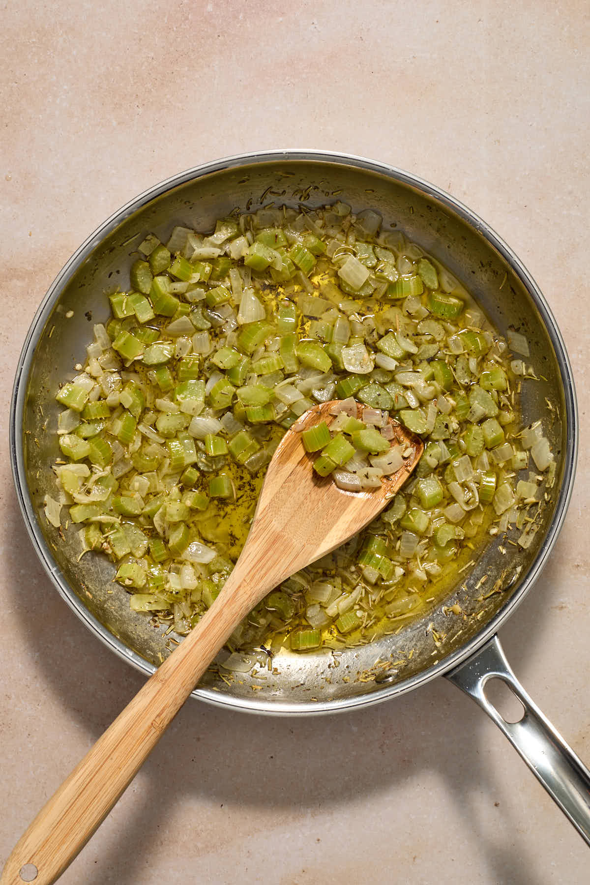 Vegetable and herb mixture cooked in butter in a skillet.