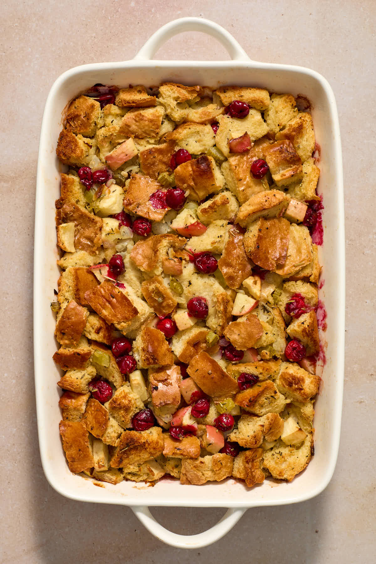 Baked stuffing in a white baking dish.