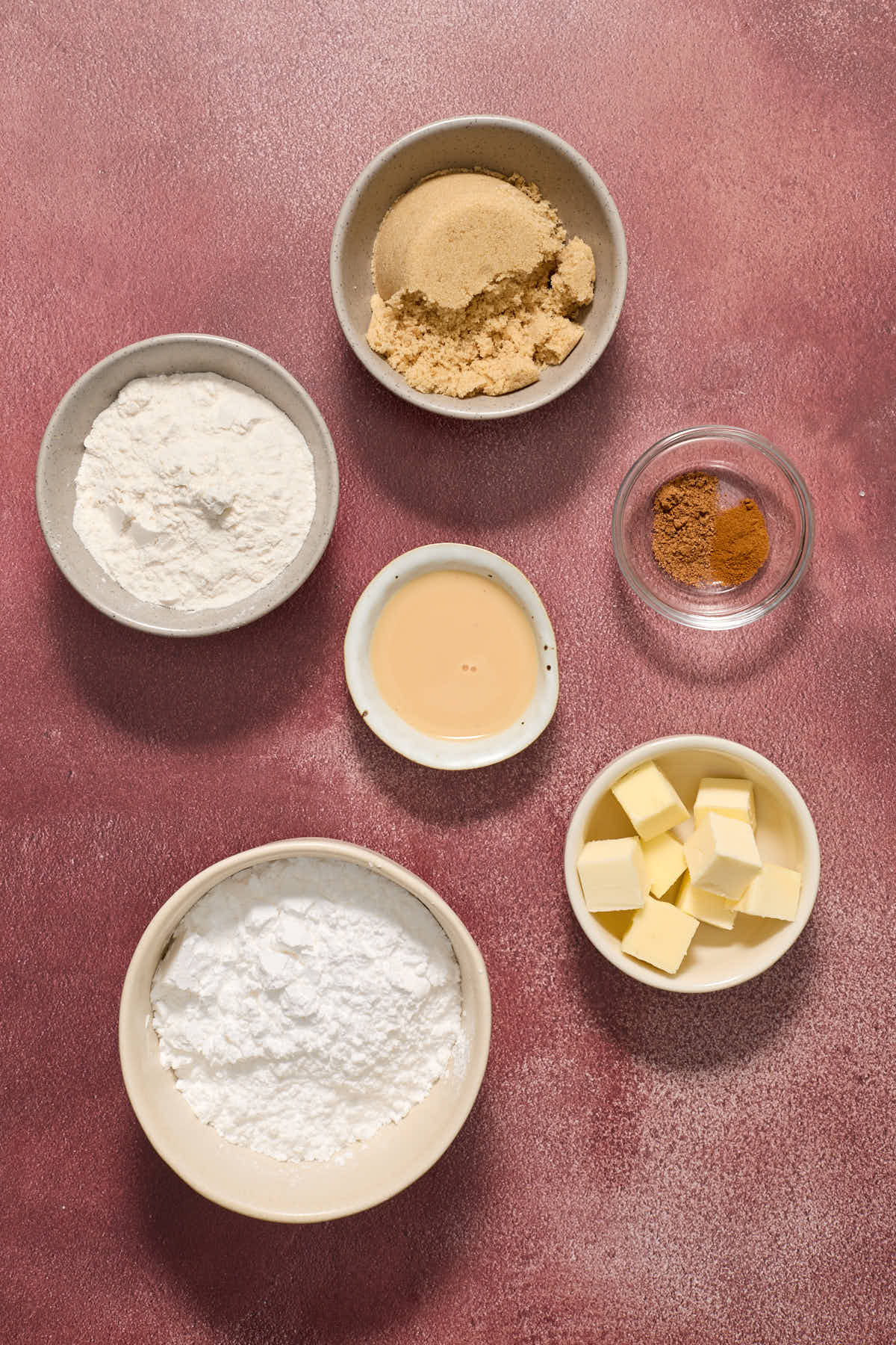Ingredients to make the streusel topping and eggnog glaze in individual bowls.