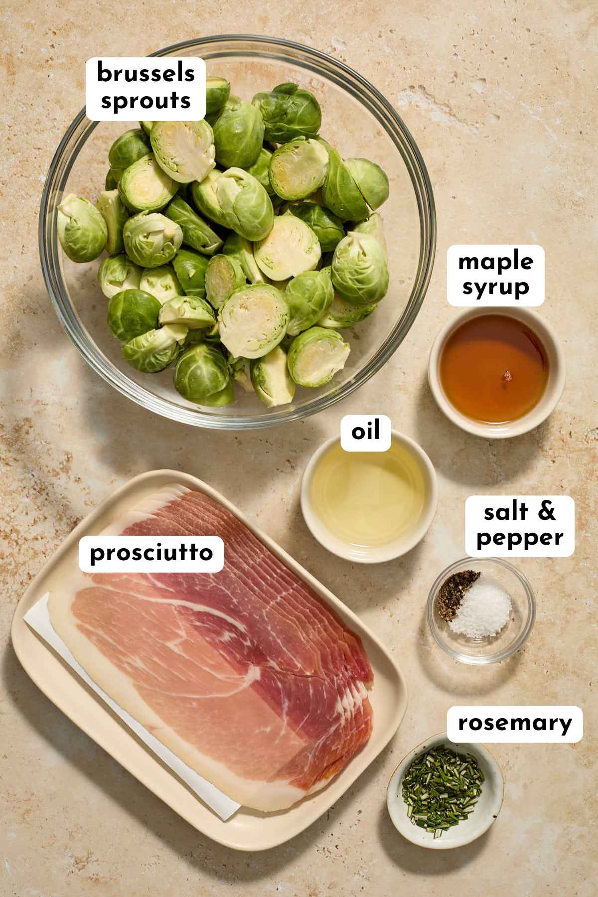 Ingredients for roasted Brussels sprouts and prosciutto arranged individually and labeled.