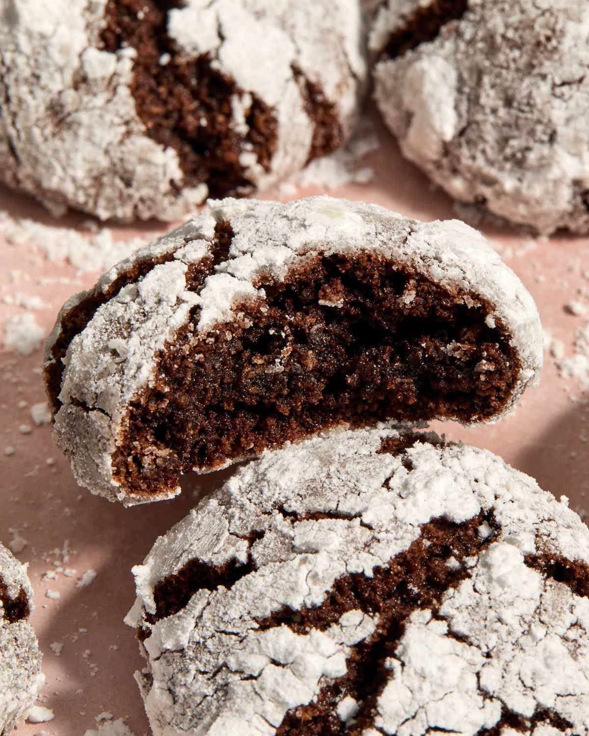 Close up of a cookie with a bite removed resting on top of another cookie.