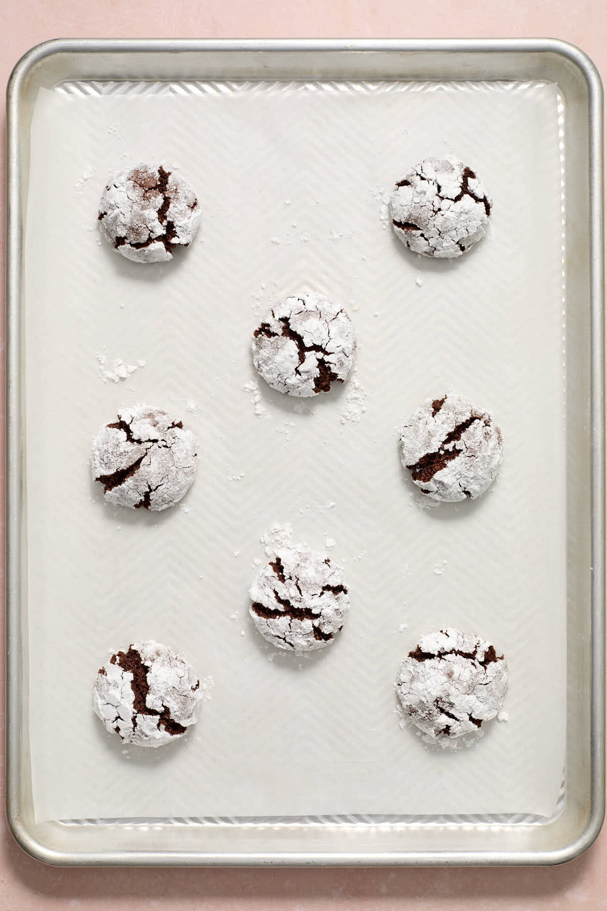 Baked cookies on a parchment lined baking sheet.