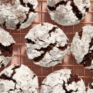 Almond Flour Chocolate Crinkle Cookies arranged close together on a wire rack.