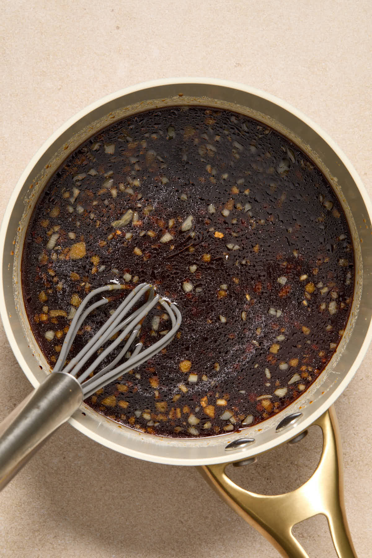 Ingredients to make honey garlic sauce in a small saucepan before it is thickened.