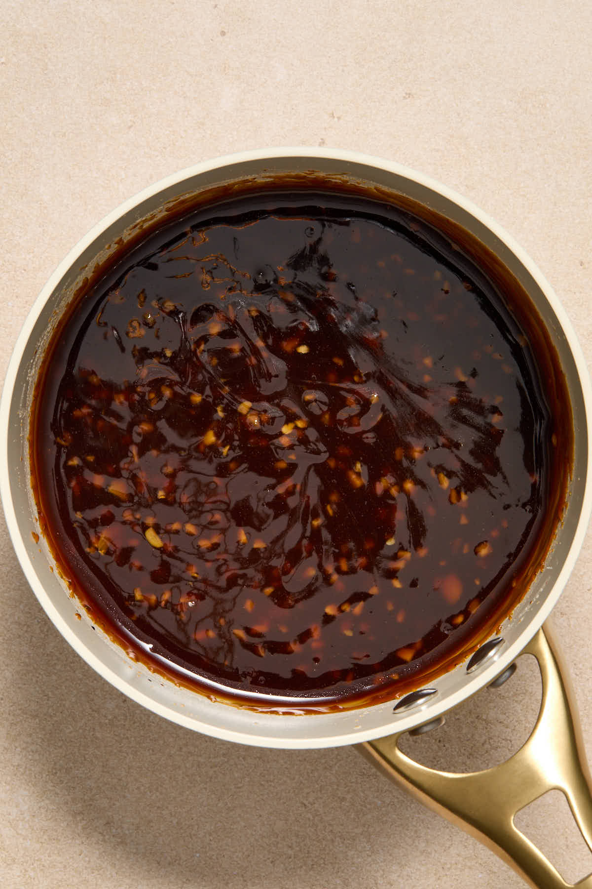 Thickened honey garlic sauce in a small sauce pan.