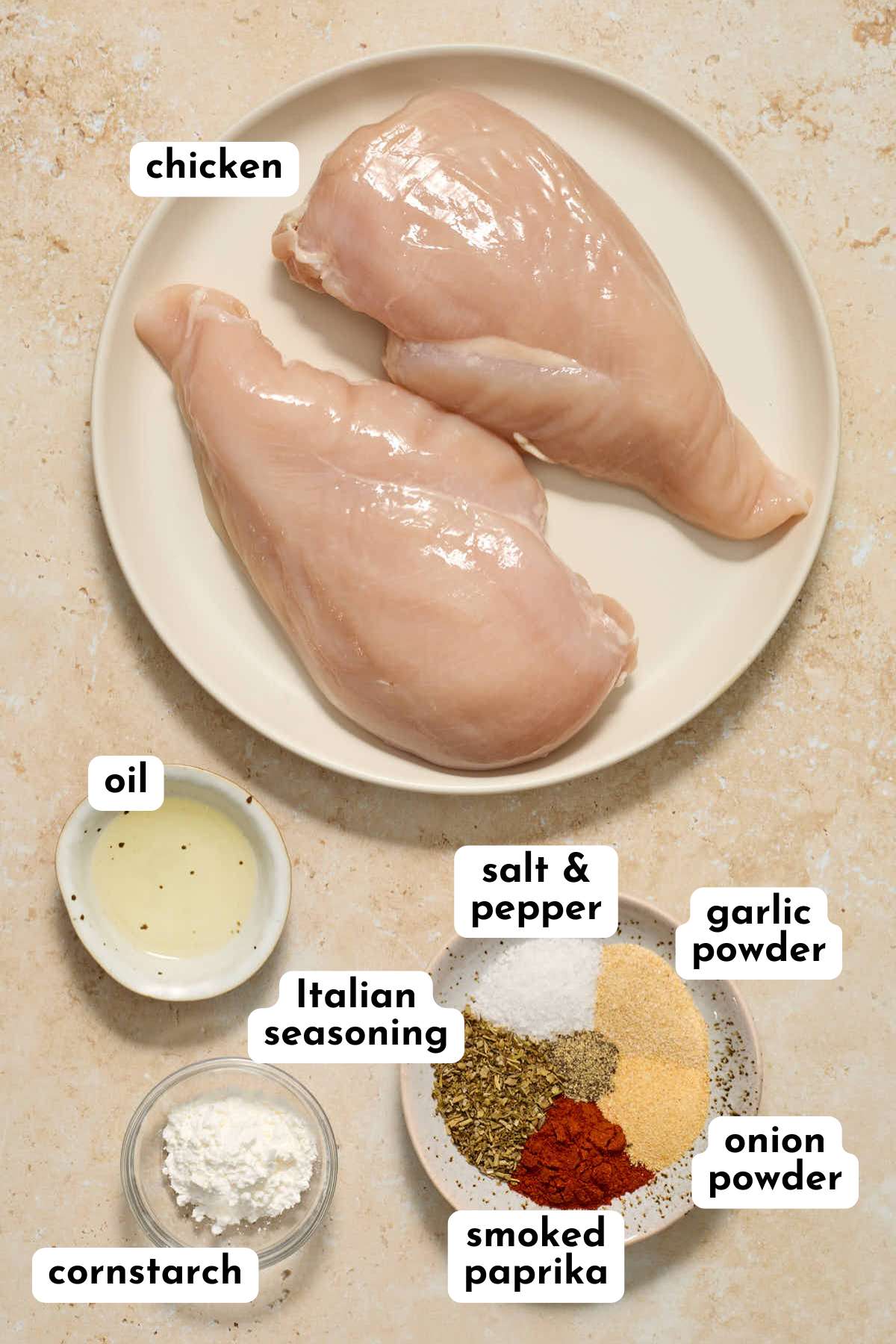 Ingredients to make air fryer chicken cutlets arranged individually and labeled.