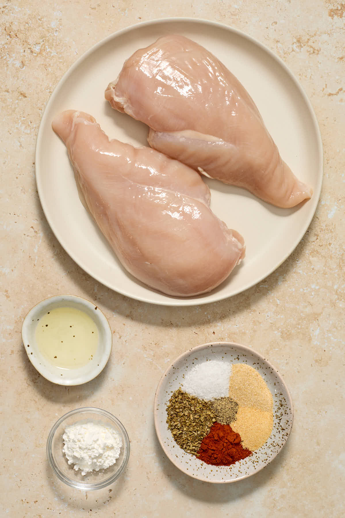Ingredients to make air fryer chicken cutlets arranged individually.