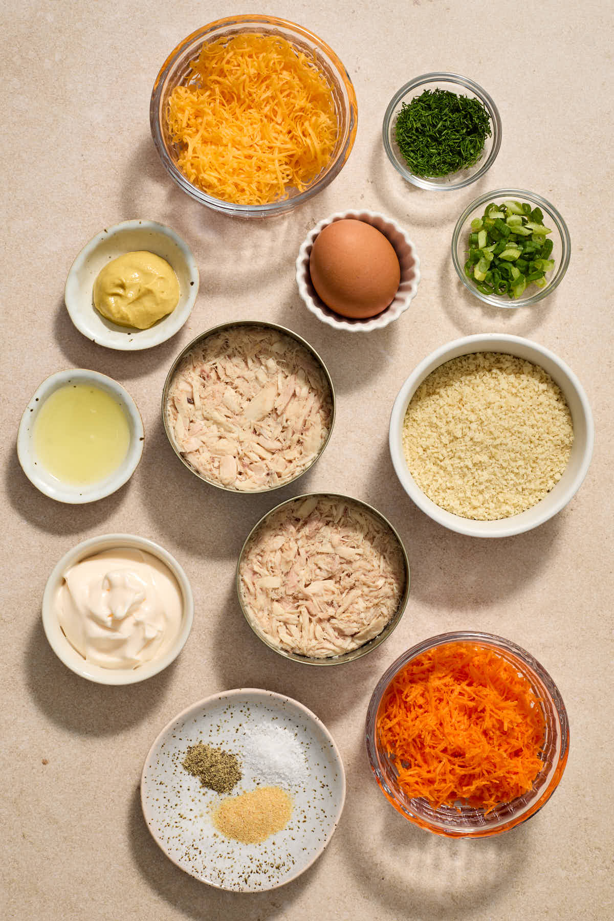Ingredients to make tuna cakes arranged individually.