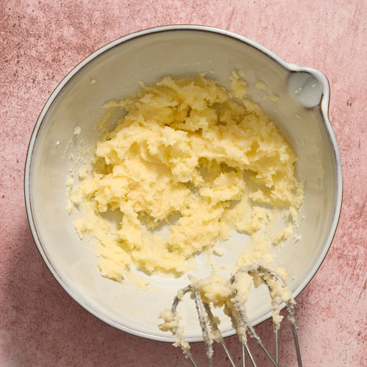 Butter and sugar creamed together in a white bowl.