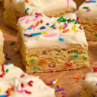 Side view of a frosted almond flour sugar cookie bar.