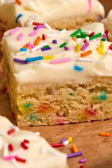 Side view of a frosted almond flour sugar cookie bar.