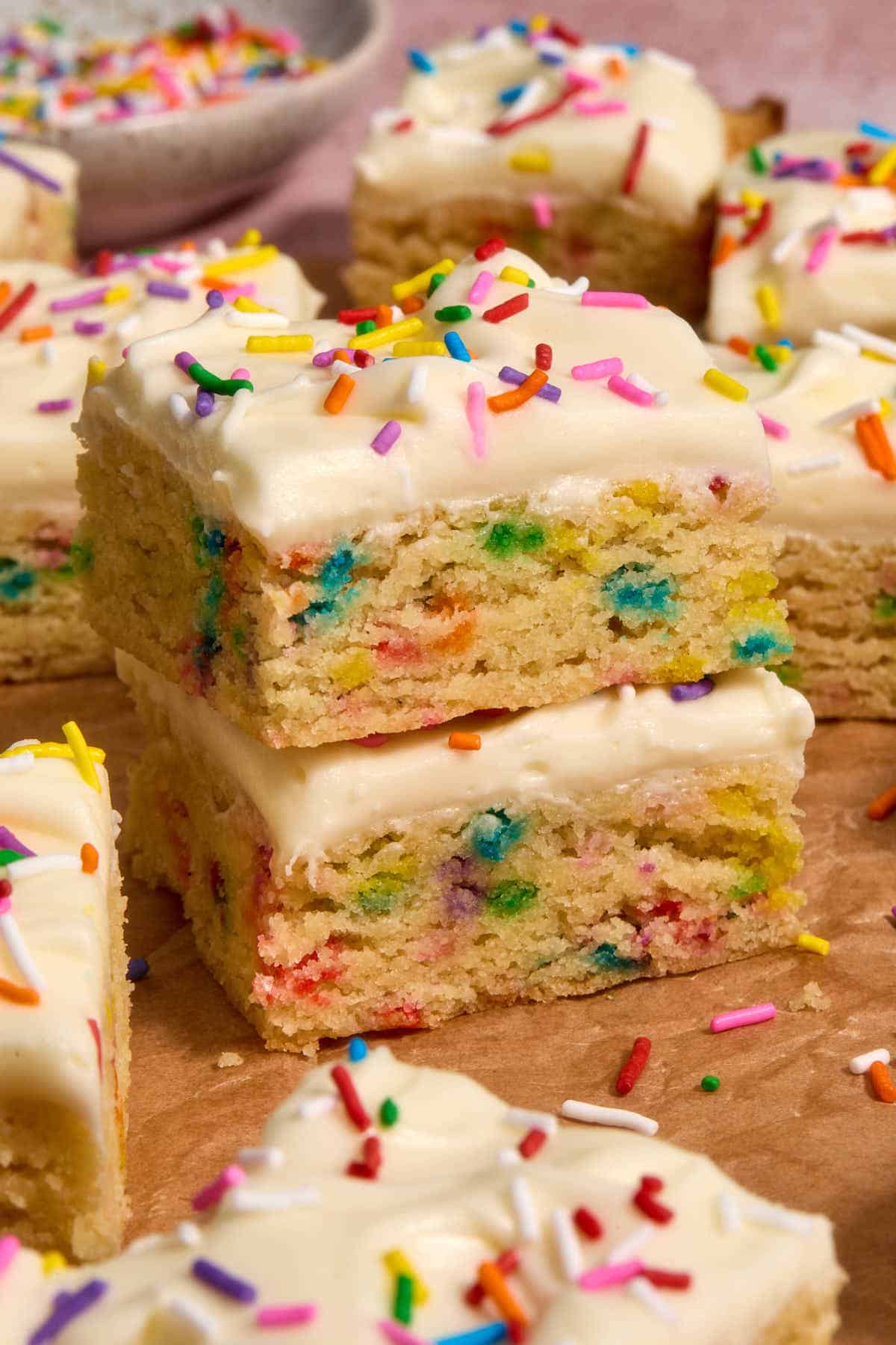 Stack of two sugar cookie bars with other bars surrounding them.