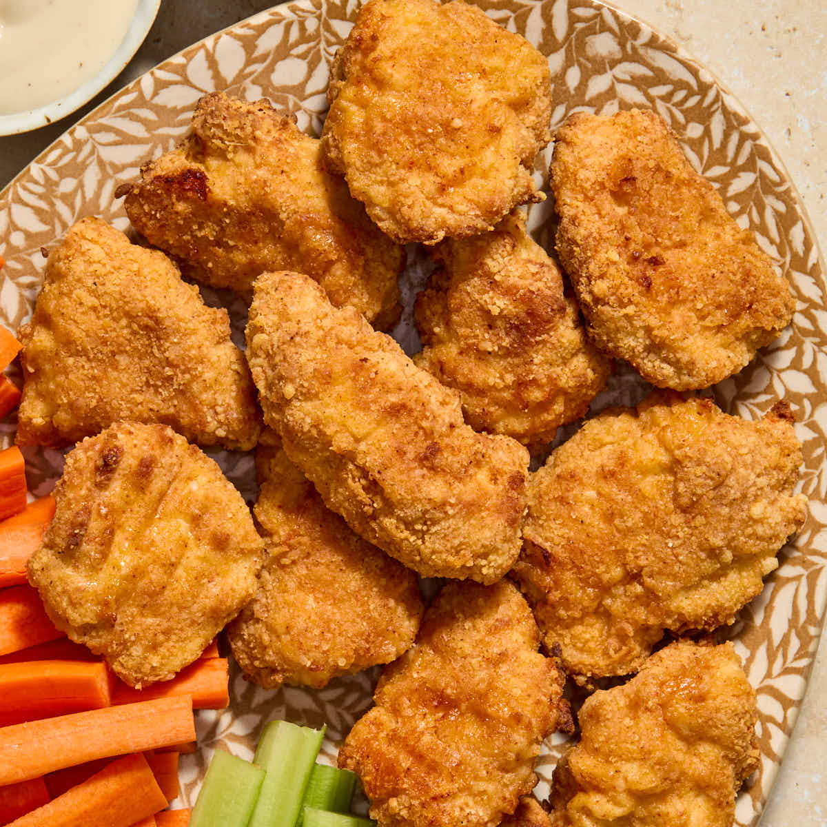 Crispy boneless chicken wings served on a platter.