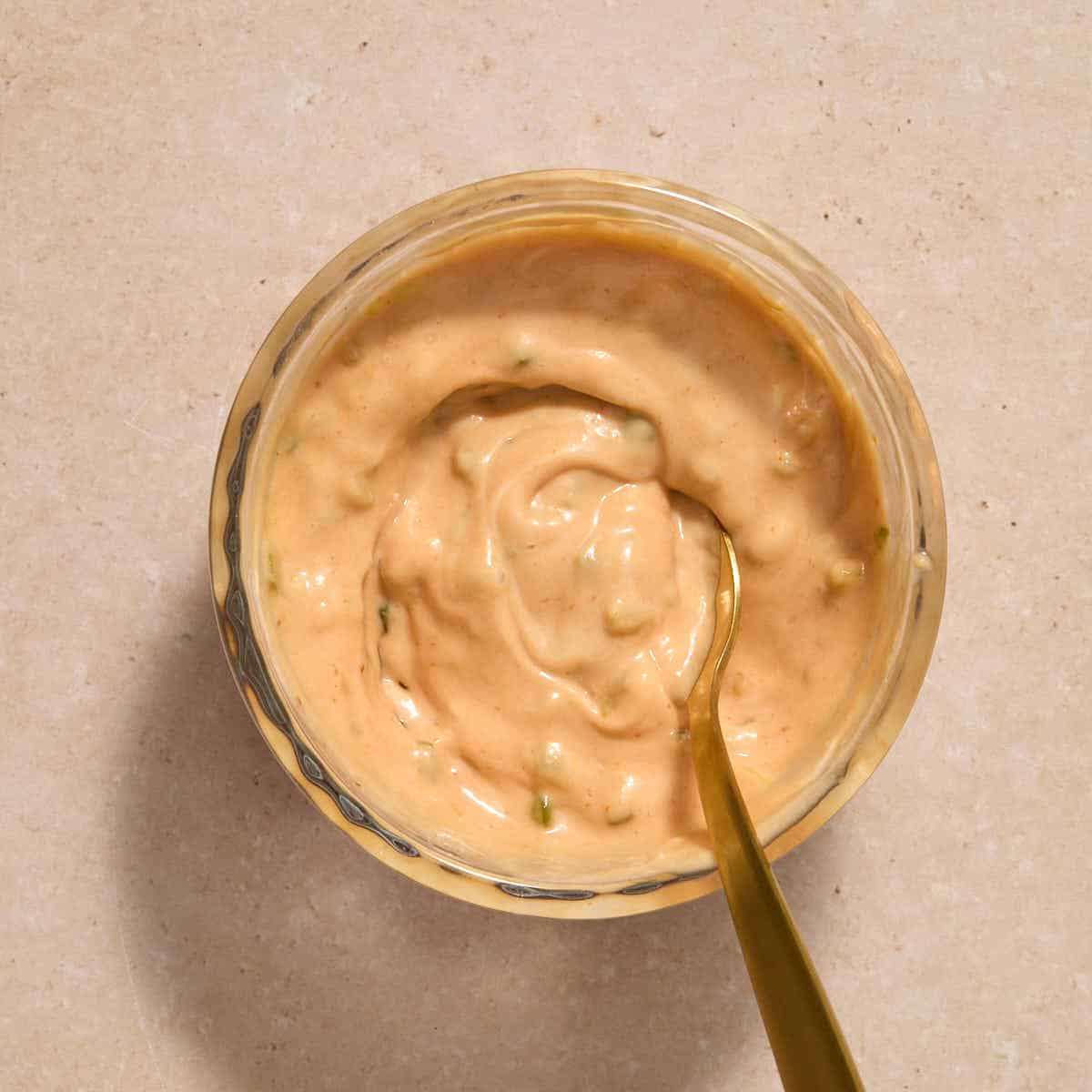 Burger sauce mixed together in a small glass bowl with a spoon.