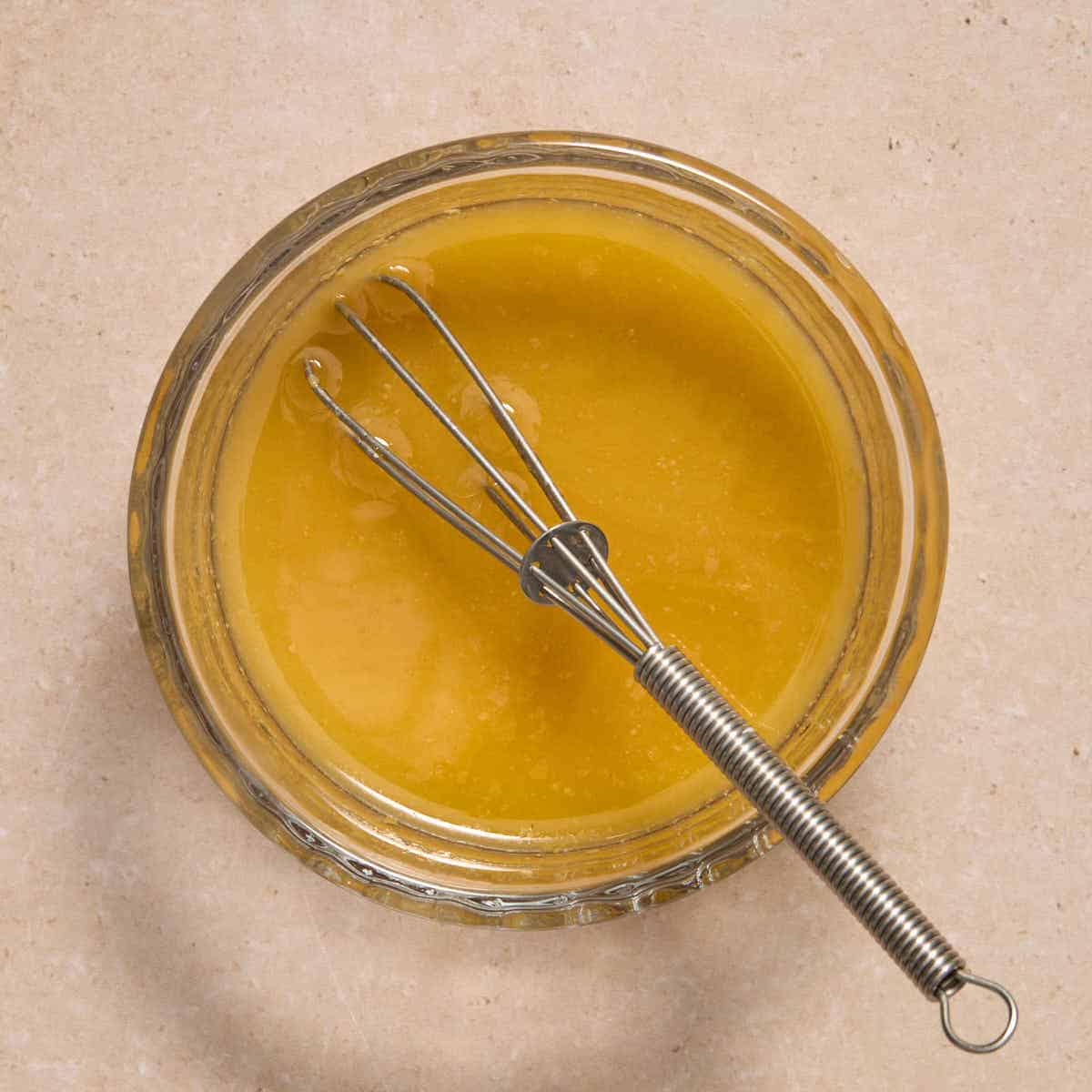 Melted butter mixture whisked together in a small glass bowl.