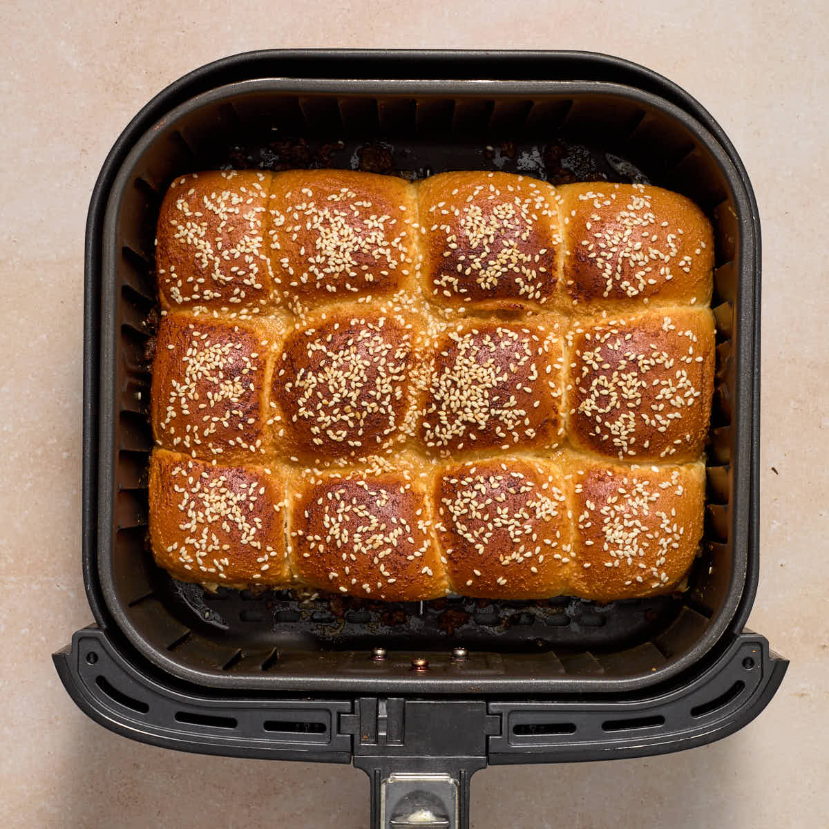 Air fried sliders fully cooked in the air fryer basket.