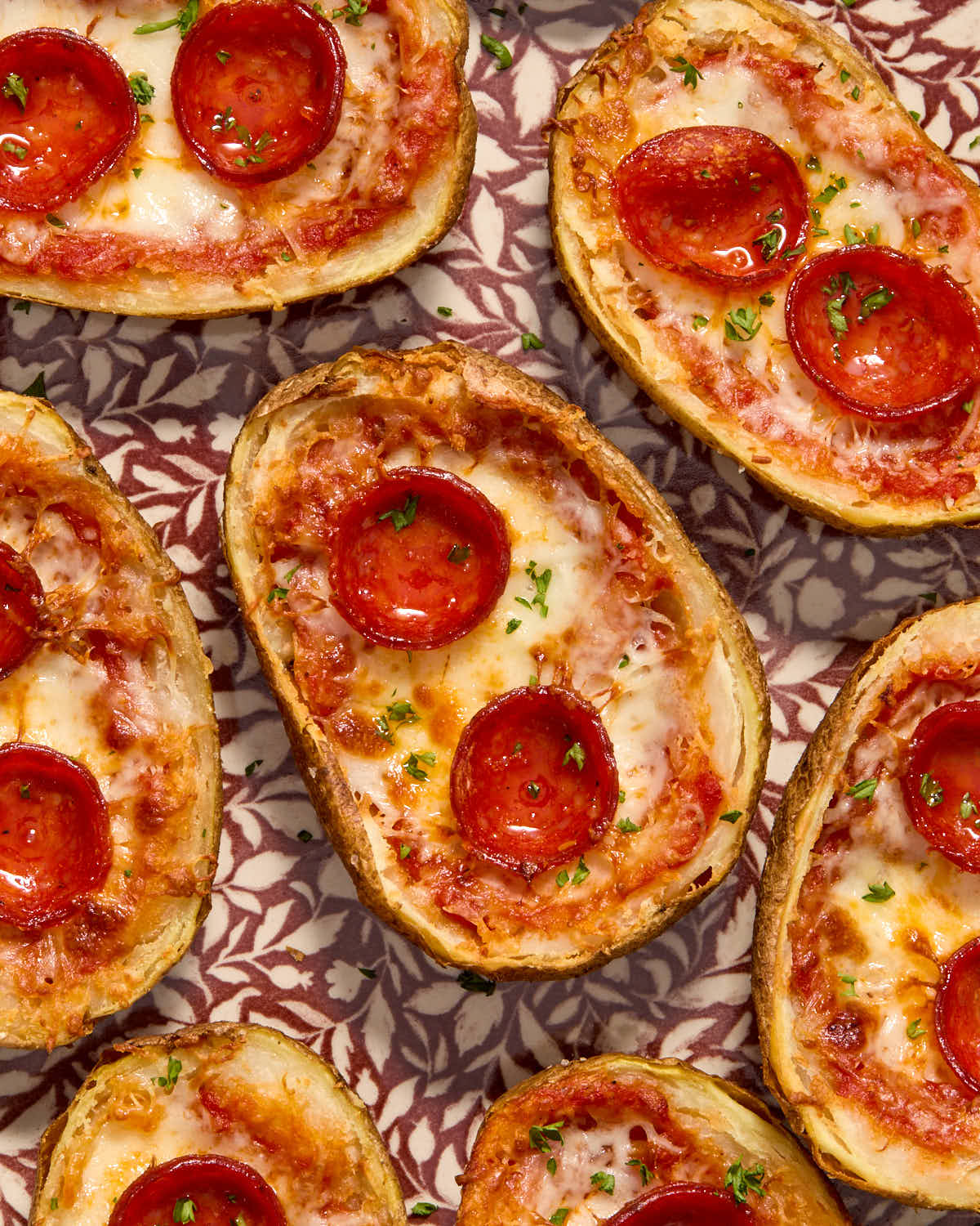 Close up of pizza style potato skins on a platter.