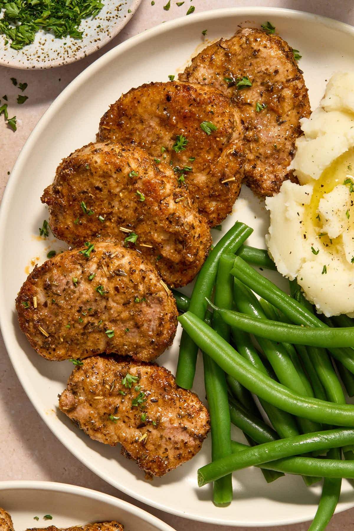 Close up view of pork medallions served on a white plate.
