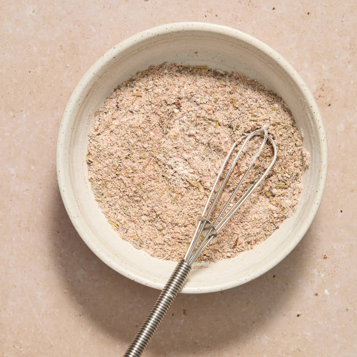 Small bowl of seasoning mixed together with a whisk.