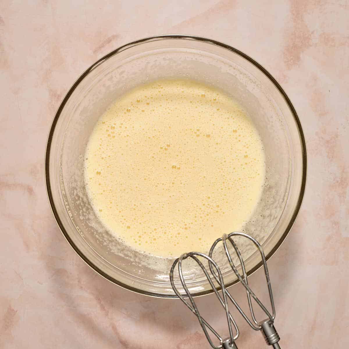 All of the wet ingredients beaten together in a glass bowl.