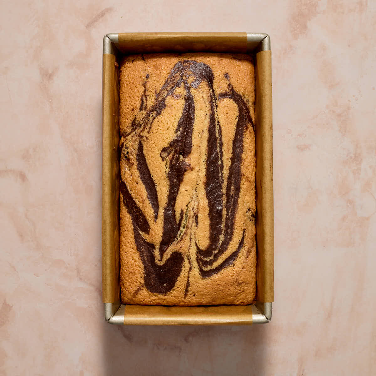 Overhead of marble loaf baked in a loaf pan.