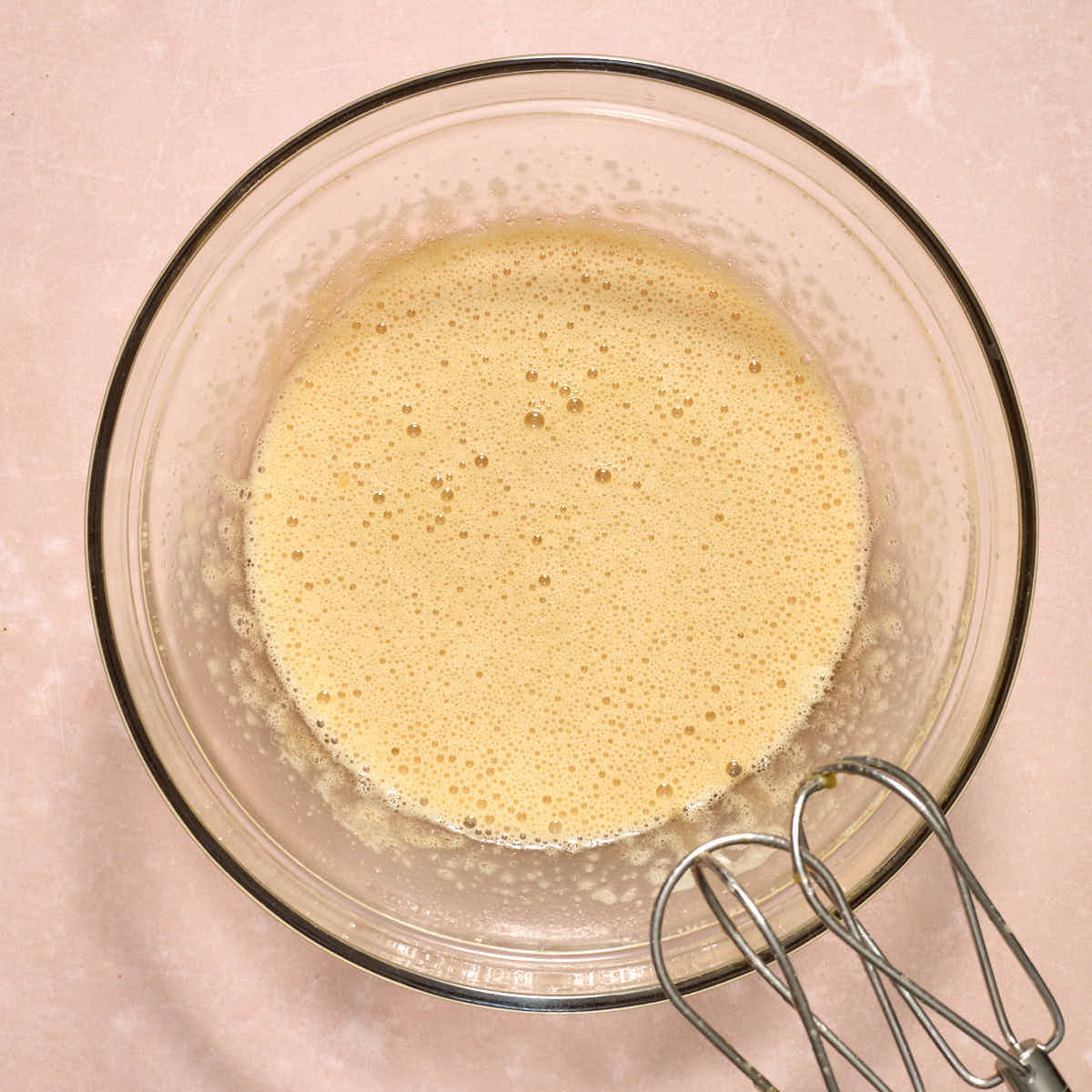 Oil and vanilla beaten into the sugar/egg mixture.