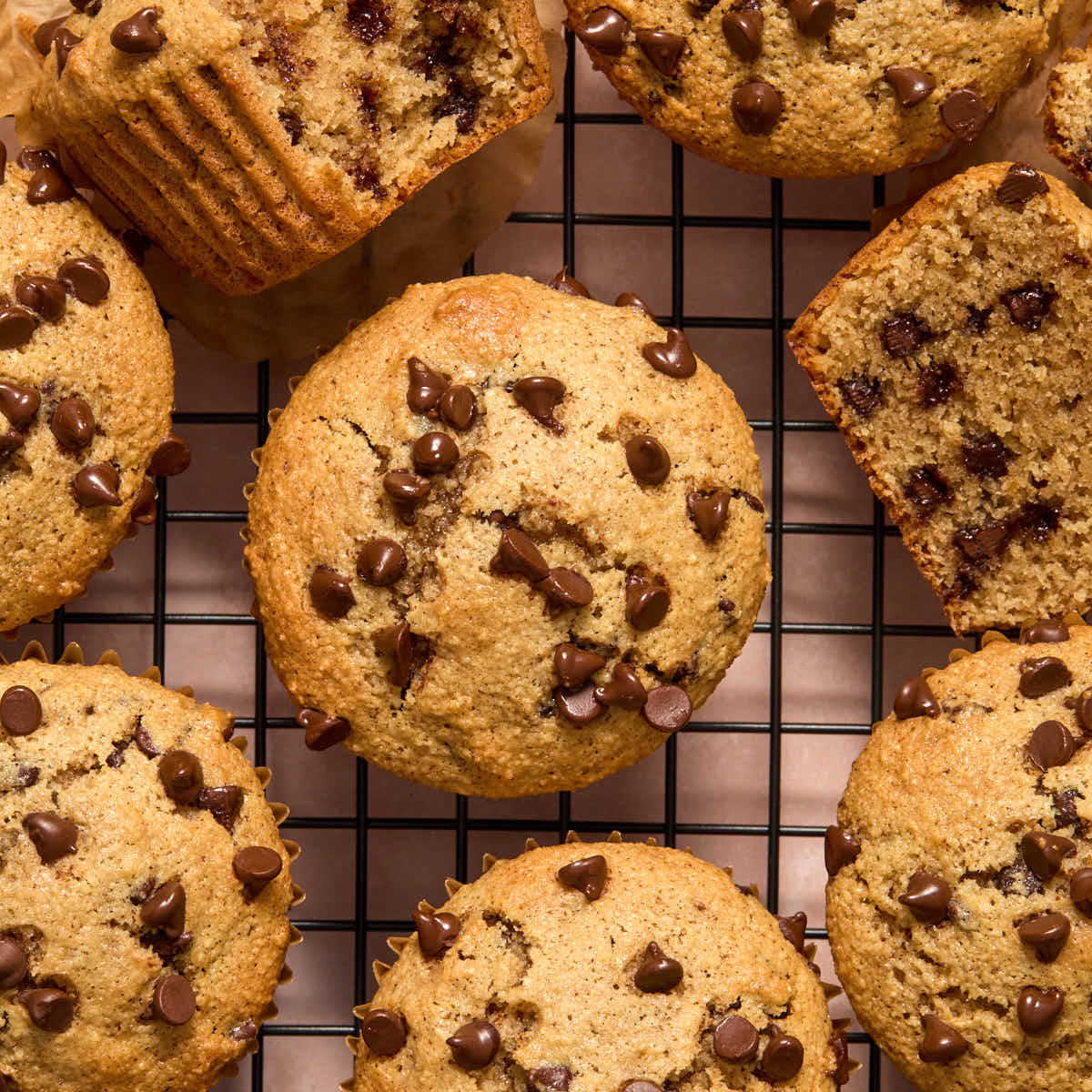Overhead of muffins cooling on a black wire rack.