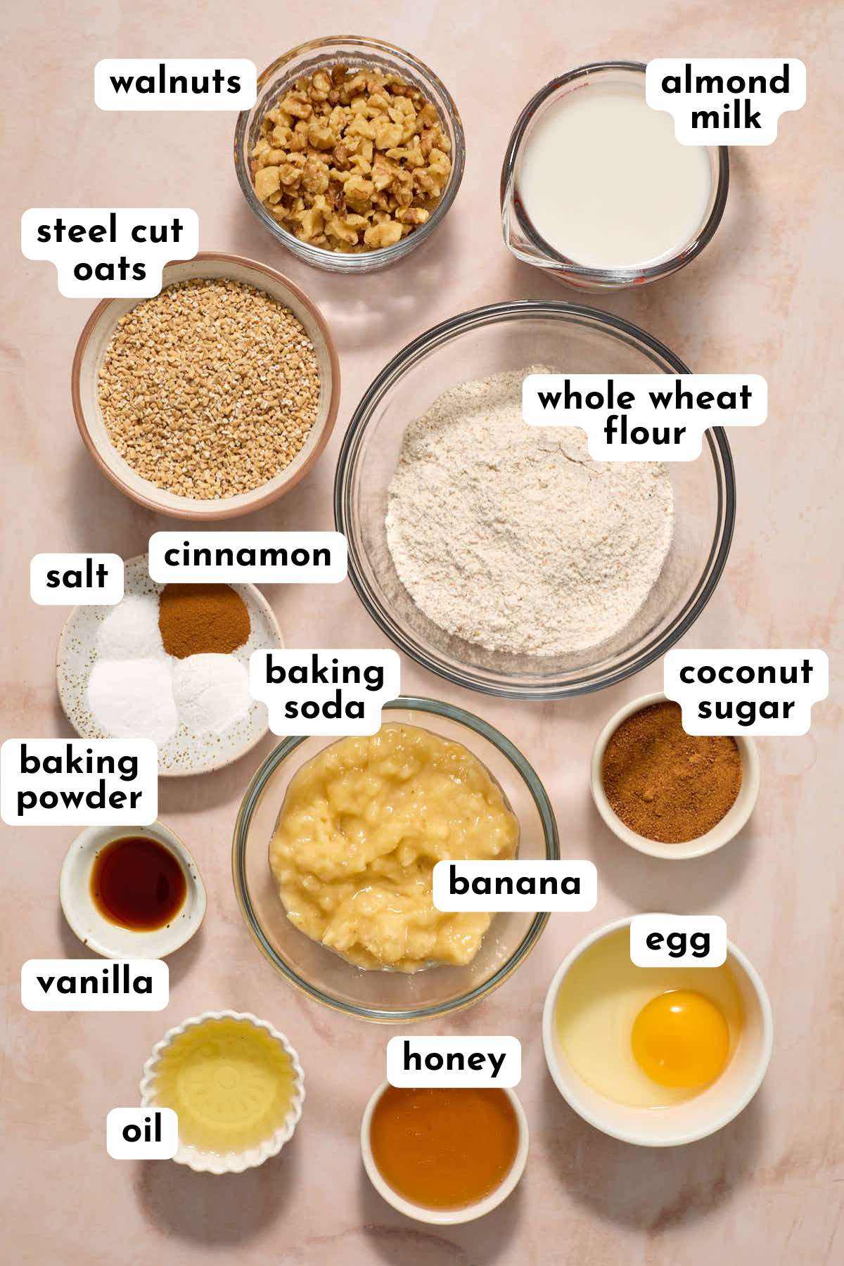 Ingredients for healthy banana nut muffins arranged individually and labeled.