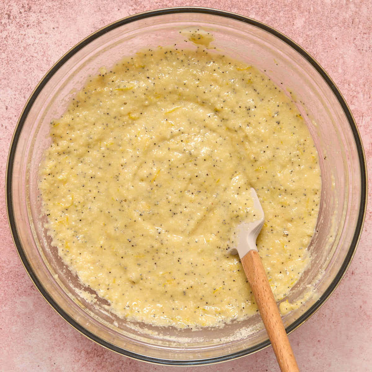 Cupcake batter fully mixed together in a bowl with a spatula.