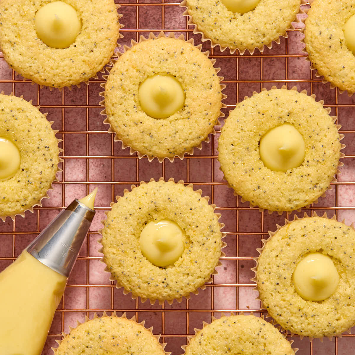 Lemon curd piped into cupcakes.
