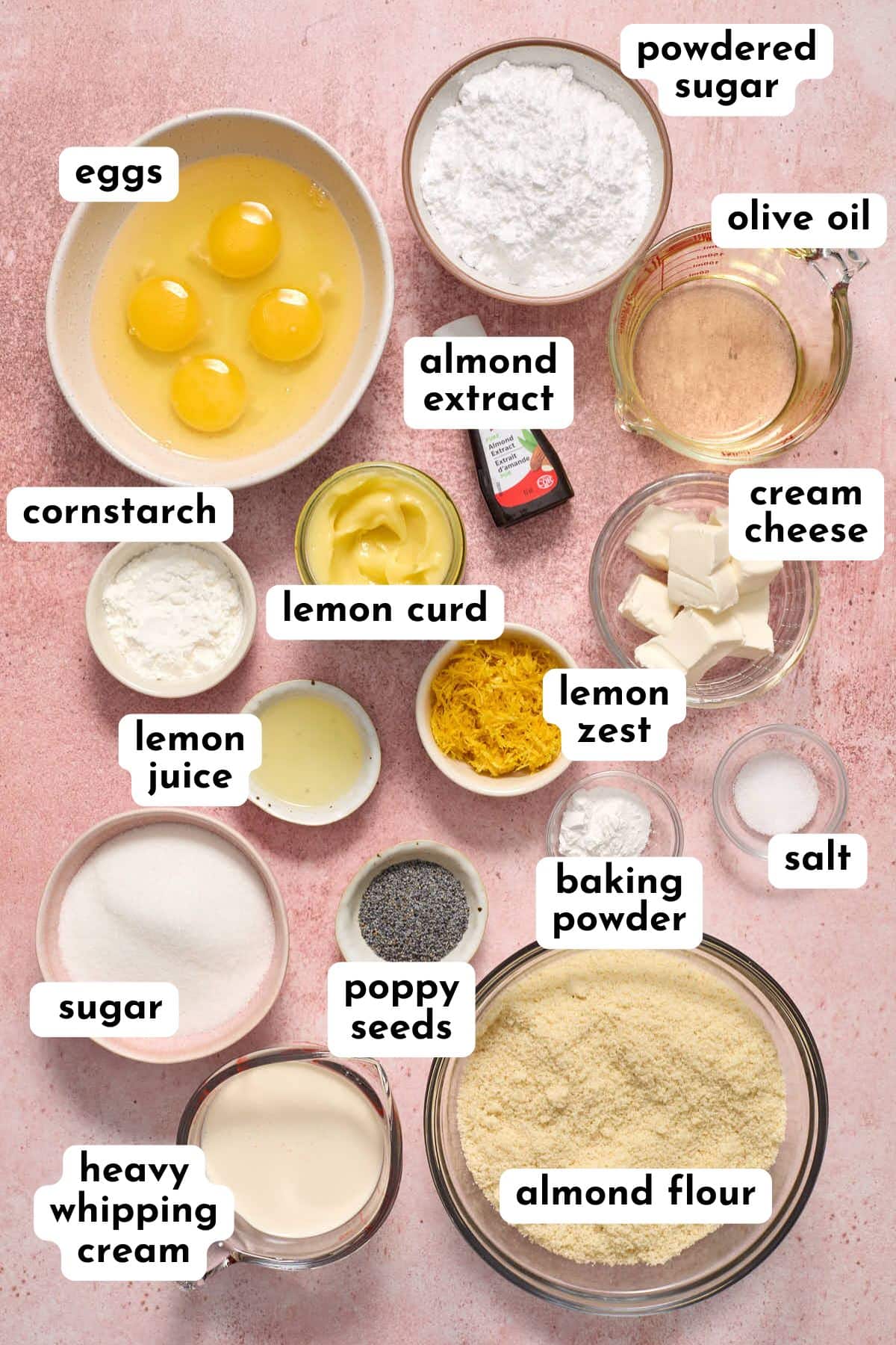 Ingredients to make lemon poppy seed cupcakes and frosting arranged individually and labeled.
